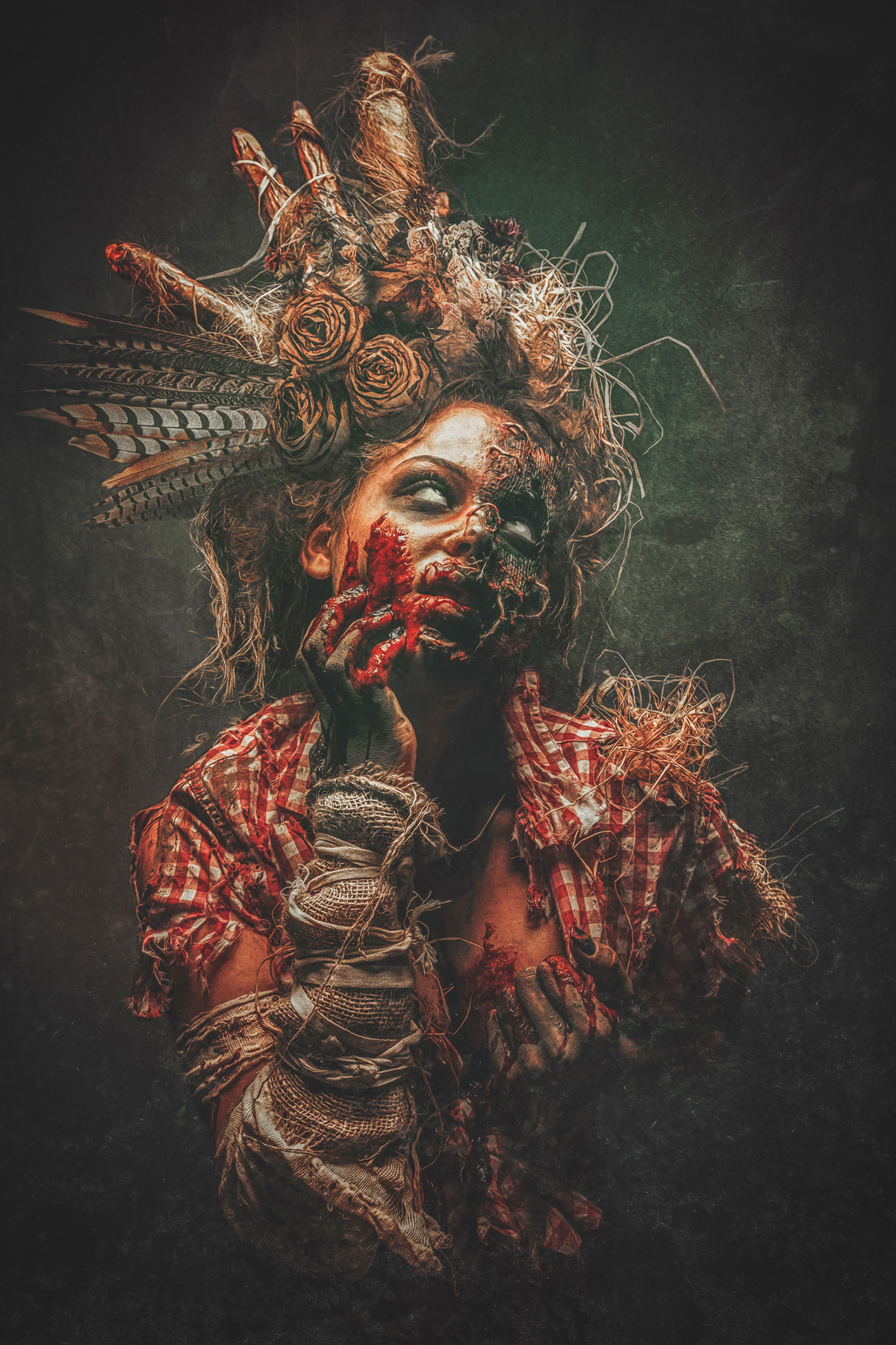 A dramatic horror portrait of a female scarecrow figure with decaying skin and white eyes, wearing a red checkered shirt and an elaborate headpiece made of straw, feathers, and dried roses.